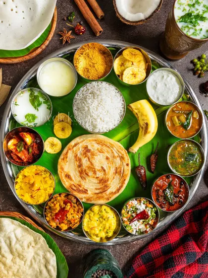 A grand South Indian thali, showcasing a wide variety of dishes on a single platter. This vibrant flatlay is a feast for the eyes.