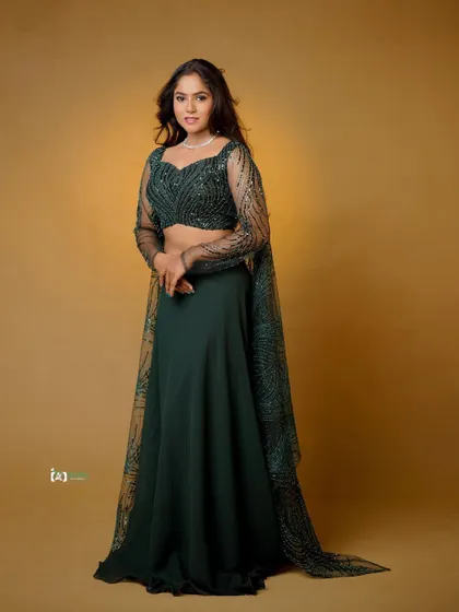 A classic full-length portrait that showcases the entire lehenga. The pose is confident and elegant, perfect for a festive or pre-wedding photoshoot.