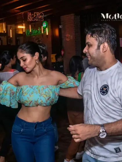 A fun and flirty dance moment captured at our weekly social. The energy is always high, and the dance floor is always full.