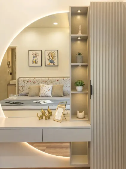 A chic dresser with a backlit half-round mirror and an attached tall unit with fluted details, providing ample and stylish storage.