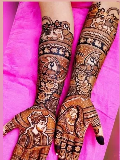 This design features a handsome portrait of the groom on one palm and the beautiful bride on the other, with peacocks and elephants on the arms.