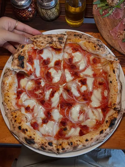 A top-down view of the Goan Sausage pizza, ready to be shared. Or not.
