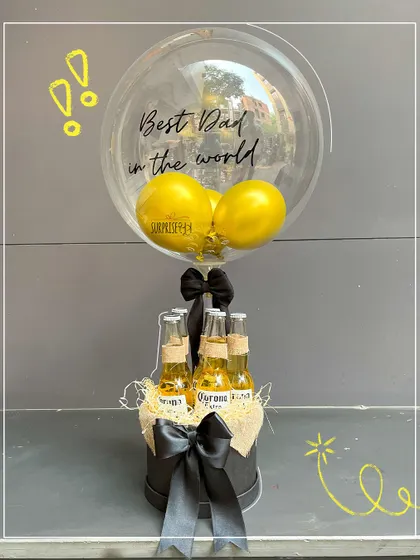 A "Best Dad in the world" beer bouquet. This fun arrangement includes a personalized bubble balloon and a selection of beers, making it a perfect Father's Day treat.