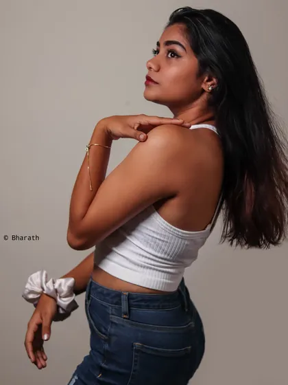 A profile shot in the studio against a neutral backdrop. This pose highlights the subject's features and creates a classic, thoughtful portrait.