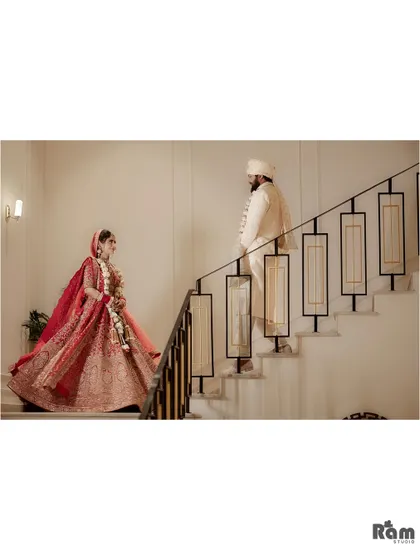 A stylish and modern wedding portrait of the couple on a staircase. The composition is clean and architectural, creating a unique and elegant image.