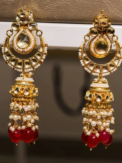 A detailed close-up of traditional gold and pearl jhumka earrings. This shot highlights my expertise in jewelry photography, focusing on intricate details and craftsmanship.