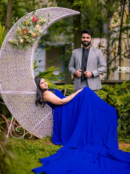 A regal and relaxed pose on the crescent moon prop. The bride's royal blue gown pools around her, creating a rich and luxurious feel for this portrait.