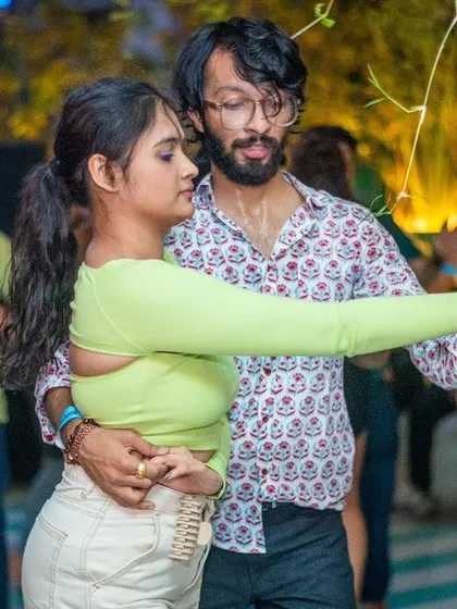 A focused and stylish pair, lost in the music.