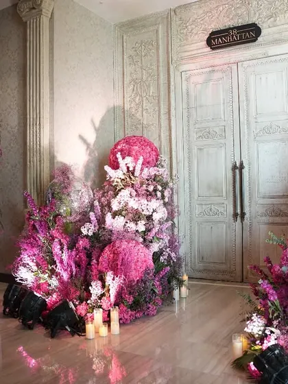 Pink hues, floral beauty, and mehendi moments to treasure. This entrance to the Manhattan bar at St. Regis was transformed into a floral fairytale with masses of pink flowers and soft candlelight, welcoming guests to a dreamy celebration.