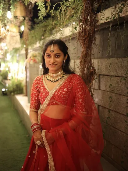 A close-up of the beautiful detailing on the rented red lehenga and the intricate necklace set. It's all about getting the complete look right.