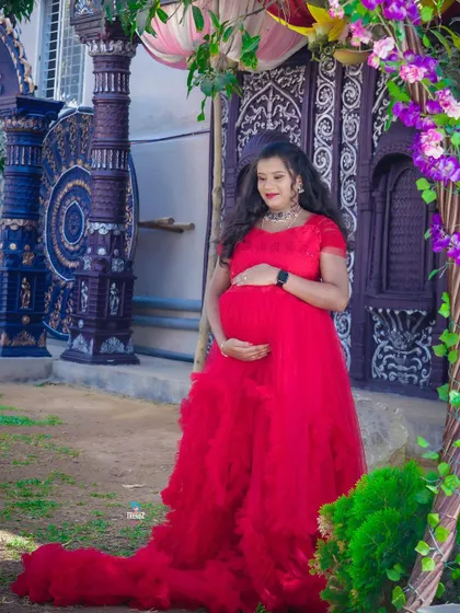 This outdoor location has such beautiful, ornate doors. The vibrant red gown creates a stunning contrast, making for a very grand portrait.