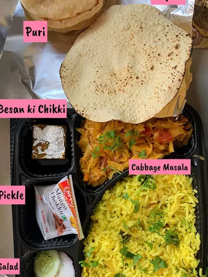 A ready-to-eat meal plate I sent out for an exhibition. This one has Lemon Rice, Cabbage Masala, Puri, Papad, Salad, Pickle, and Besan ki Chikki.