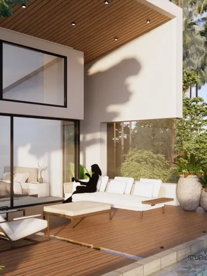 The deck area of the Pai Residence, featuring a comfortable outdoor sofa. This space is designed as an extension of the indoor living area, providing a private, open-air lounge with a direct view of the infinity pool and the river.