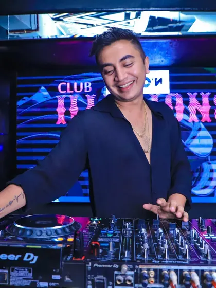 A happy moment behind the Pioneer DJ setup at Club Illusions. The right gear and a great crowd are the perfect recipe for an amazing night.