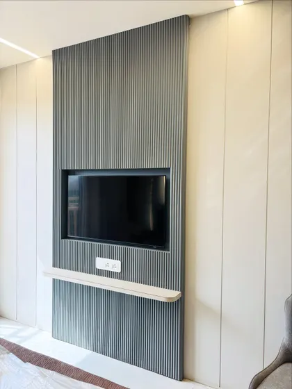 A still shot of the sleek, wall-mounted TV panel. This design is ideal for smaller bedrooms as it takes up zero floor space.