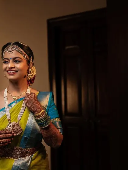 A getting-ready shot of this lovely bride. Her makeup is soft and elegant, with a focus on enhancing her natural features for a timeless look.
