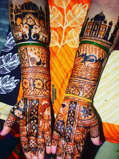 This is a storytelling masterpiece, featuring the Taj Mahal, royal elephants, a wedding doli scene, and bride and groom figures. It's a complete wedding story on two arms.