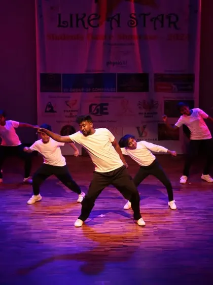 A dynamic group performance with an instructor at the center.