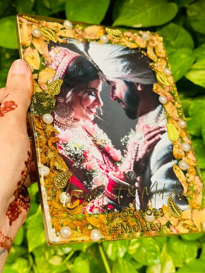 A beautiful 5x7 inch rectangular plate preserving a couple's wedding memories. The frame is made entirely of preserved leaves and flowers from their varmala, creating a natural and stunning border for their photo.