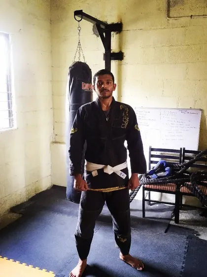 Standing in my Gi at the academy. The Gi is a traditional uniform for BJJ that adds a layer of complexity with grips and friction, making your technique sharper.