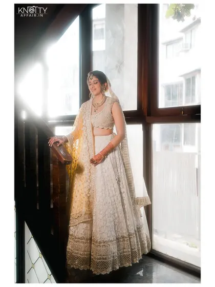 An elegant bridal portrait by a window, using the bright natural light to create a soft and ethereal glow.