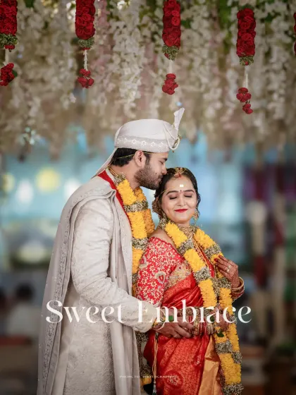 'Sweet Embrace'. A romantic portrait of the groom embracing his bride from behind, a classic and timeless wedding pose.