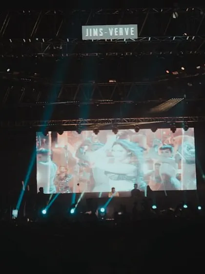 The full stage setup at JIMS Verve in Delhi, showcasing the large LED screen and lighting rig I use for my campus shows.