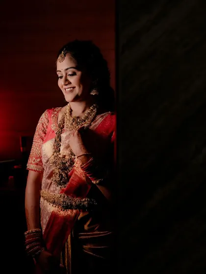 A stunning solo portrait of the bride at her reception, with dramatic lighting creating a sophisticated and timeless image.