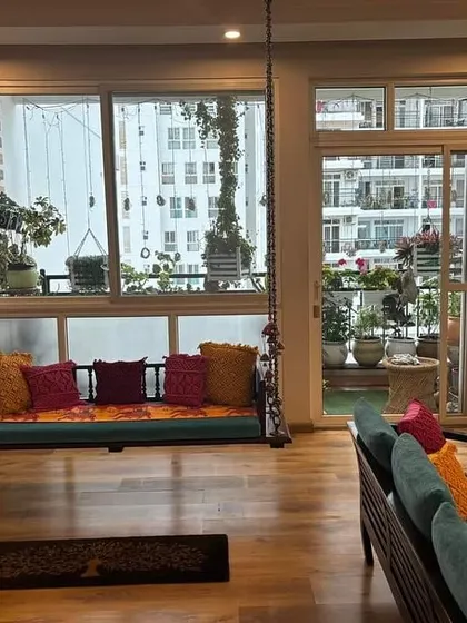 The vibrant cushion covers look amazing on the indoor swing in my client's living room.
