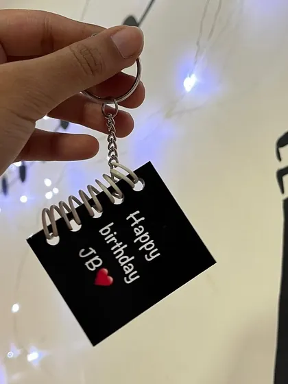 The cover of a mini booklet keychain, personalized with a birthday message.