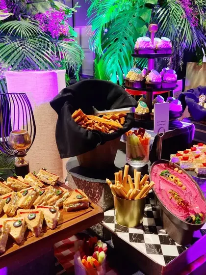 Our grazing tables are designed for easy enjoyment. Here you can see a mix of sandwiches, fries, and dips, perfect for guests to grab while they mingle and enjoy the event.