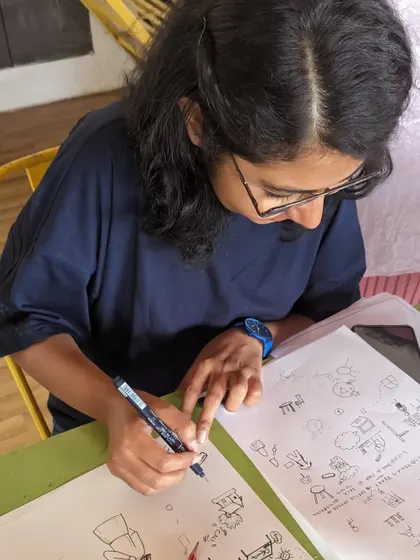 A participant engrossed in a doodling workshop, creating a page full of imaginative characters and designs.