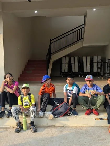 A group of boys taking a break on the steps after a morning activity. We balance high-energy activities with downtime for rest and socializing.