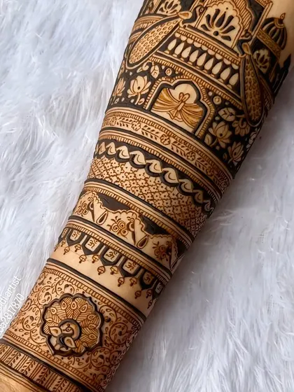 A close-up shot of the fine line work on a bridal forearm design. You can see the detail in the peacock and the delicate floral patterns.