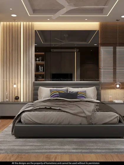 A frontal view of a master bedroom, showcasing a large mirrored panel behind the bed that creates an illusion of depth.