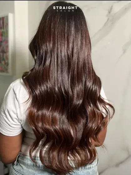 A full shot of the long, glossy hair against a marble backdrop.