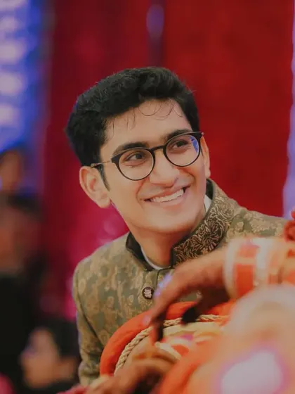 The groom's candid smile as he looks at his bride. This shot is all about capturing that pure, unfiltered moment of adoration and happiness during the wedding ceremony.