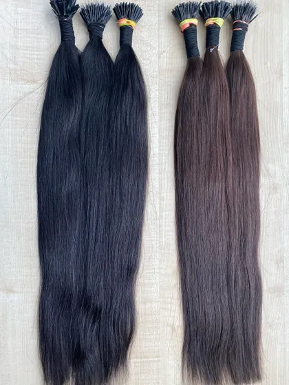 A side-by-side display of our natural black and dark brown I-Tip extensions. This helps clients and stylists visualize and select the correct shade for a seamless blend.