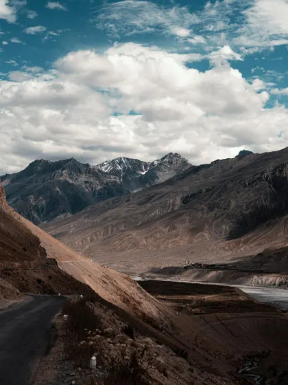 The winding roads of Spiti Valley, carved into the side of the mountains. This image showcases the scale of the landscape and the incredible engineering of the roads.