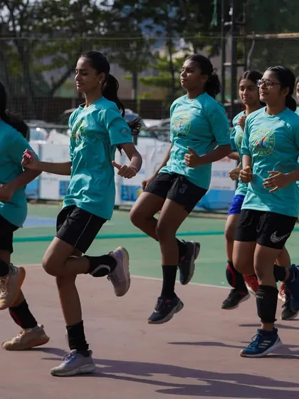 Marching in step, the team builds rhythm and energy. A good warm-up sets the tone for a productive and successful practice session.