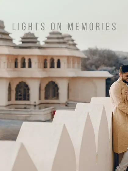A couple shares a moment on the steps of a beautiful heritage building, with our "Lights on Memories" brand mark. This is an example of our signature branded imagery.