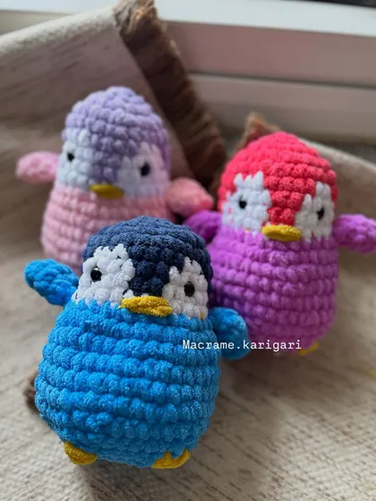 A trio of our handmade penguins in purple, pink, and blue. These little guys are perfect for gifting, and we can customize them in any color you like.