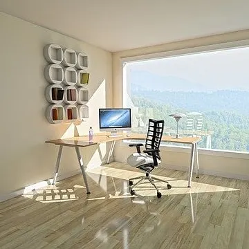 A sun-filled home office with clean, off-white walls. A professional paint job is essential for creating a bright and motivating workspace at home.