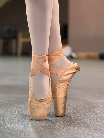 The journey to dancing en pointe is a true test of a ballerina's strength and dedication. This is a close up of our student's pointe shoes, which represent years of hard work, discipline, and the beautiful artistry of advanced ballet.