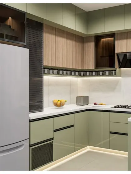 A 3D concept for a dual-tone kitchen combining sage green and natural wood. This render highlights the roller shutter appliance garage and the efficient L-shaped layout.