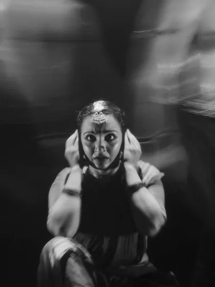 A motion-blur photograph from 'Naga Mandala' that conveys a sense of turmoil and intensity. The expressive face of the dancer is the center of the storm.