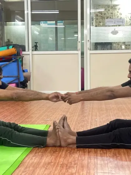 Two of our male students working together in a partner stretch. This helps improve flexibility in the back and hamstrings while building a sense of camaraderie in the class.