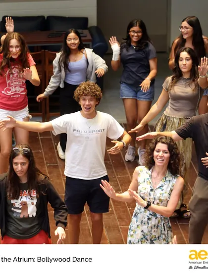 A close-up of students and a teacher learning Bollywood dance moves. The arts at AES are a powerful tool for building community and celebrating the diverse cultural backgrounds of our students and staff.