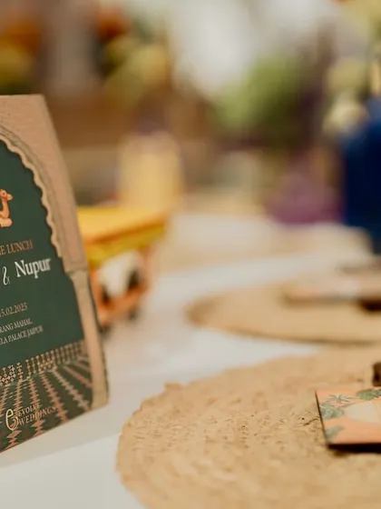A detail shot of the custom menu card, designed with a Rajasthani arch motif. It's these small, cohesive details that elevate an event from a party to a curated experience.