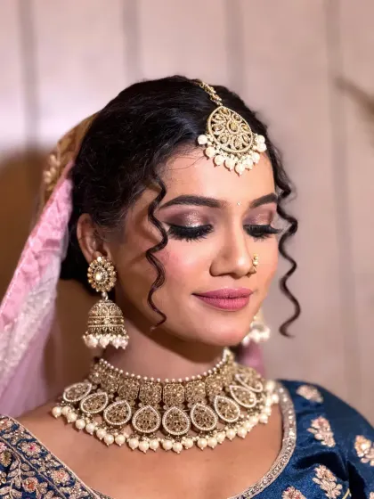 A side view of the soft glam bridal makeup, highlighting the gentle contouring and the intricate details of the hairstyle.